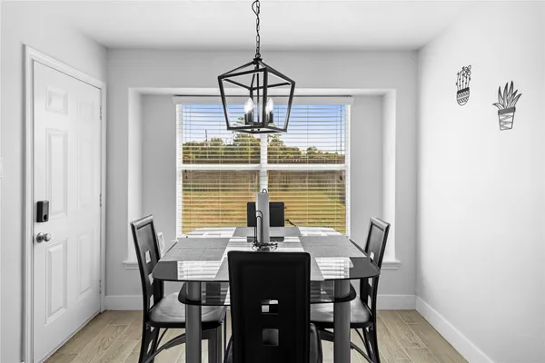 a dining room with furniture and window