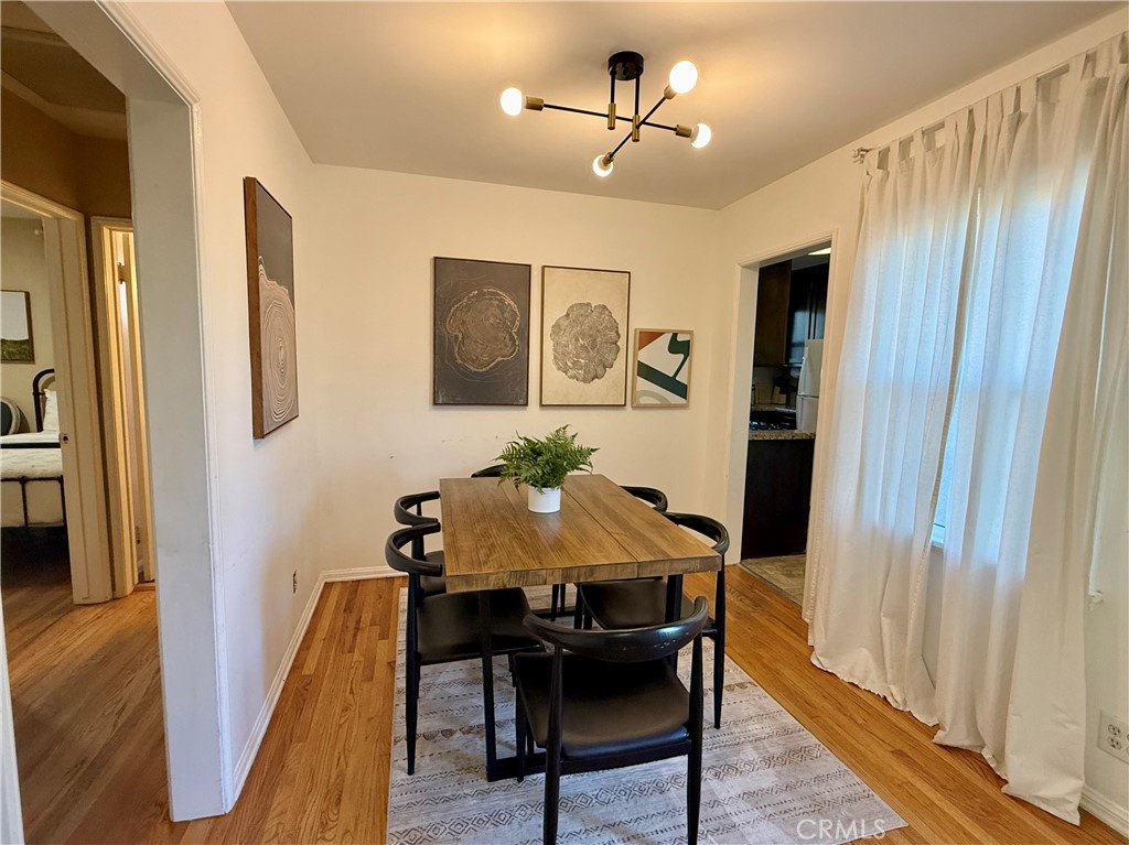 6948 Balcom Avenue Reseda, CA 91335 - Photo 13 of 30 a view of a dining room with furniture and wooden floor