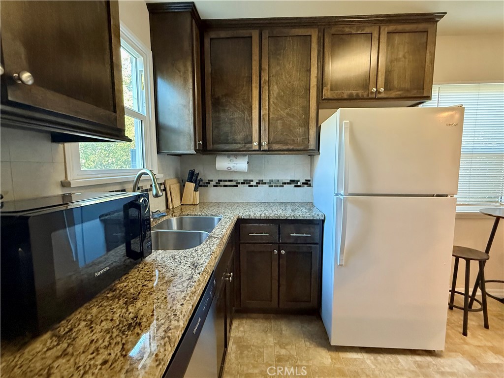 6948 Balcom Avenue Reseda, CA 91335 - Photo 18 of 30 a kitchen with stainless steel appliances granite countertop a refrigerator a sink and a stove