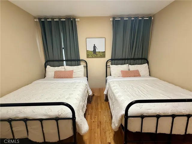 a bedroom with two beds and a window