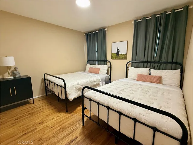 a bedroom with two beds and a dresser