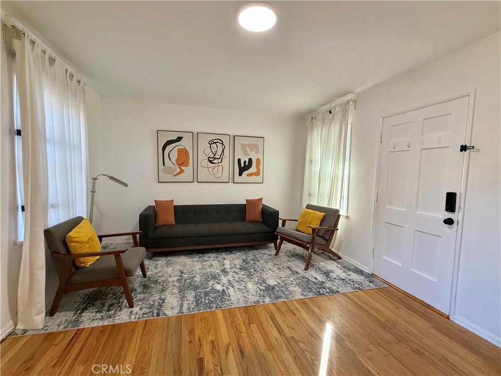 6948 Balcom Avenue Reseda, CA 91335 - Photo 7 of 30 a living room with furniture and a rug
