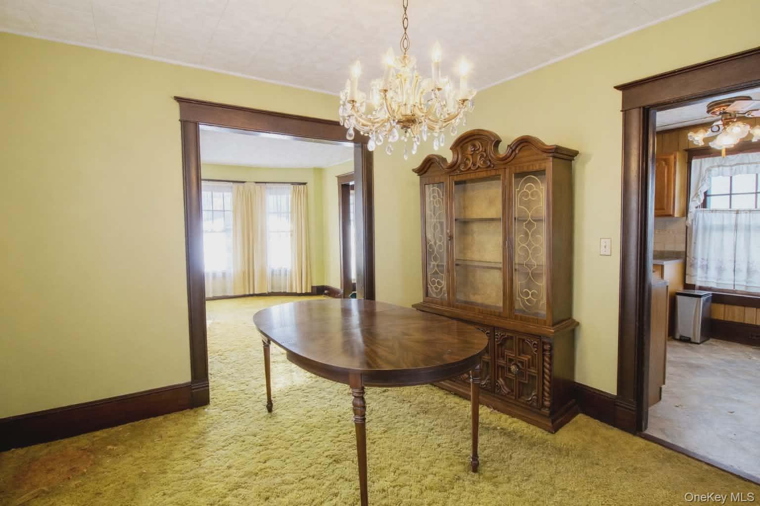 409 Baker Street Poughkeepsie, NY 12603 - Photo 3 of 23 a view of a dining room with furniture and a chandelier