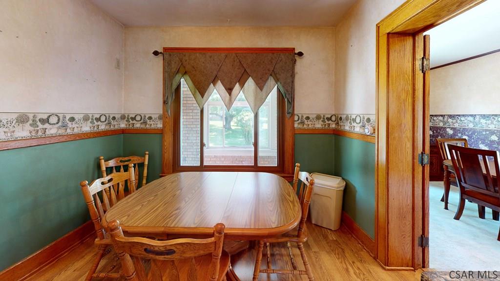 915 Miller Picking Road Davidsville, PA 15928 - Photo 4 of 30 a view of a dining room with furniture window and wooden floor