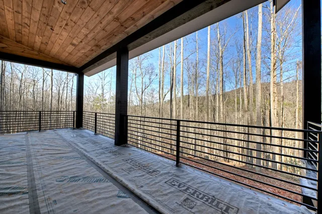 a view of a porch with wooden floor and iron stairs