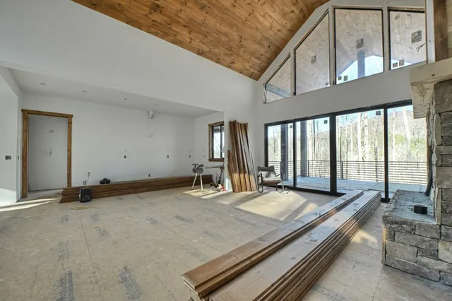 a room with pool table and windows