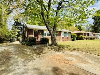 212 Beauregard Avenue Anderson, SC 29621 - Photo 2 of 5 This charming residence offers a warm and inviting curb appeal with a classic brick facade.