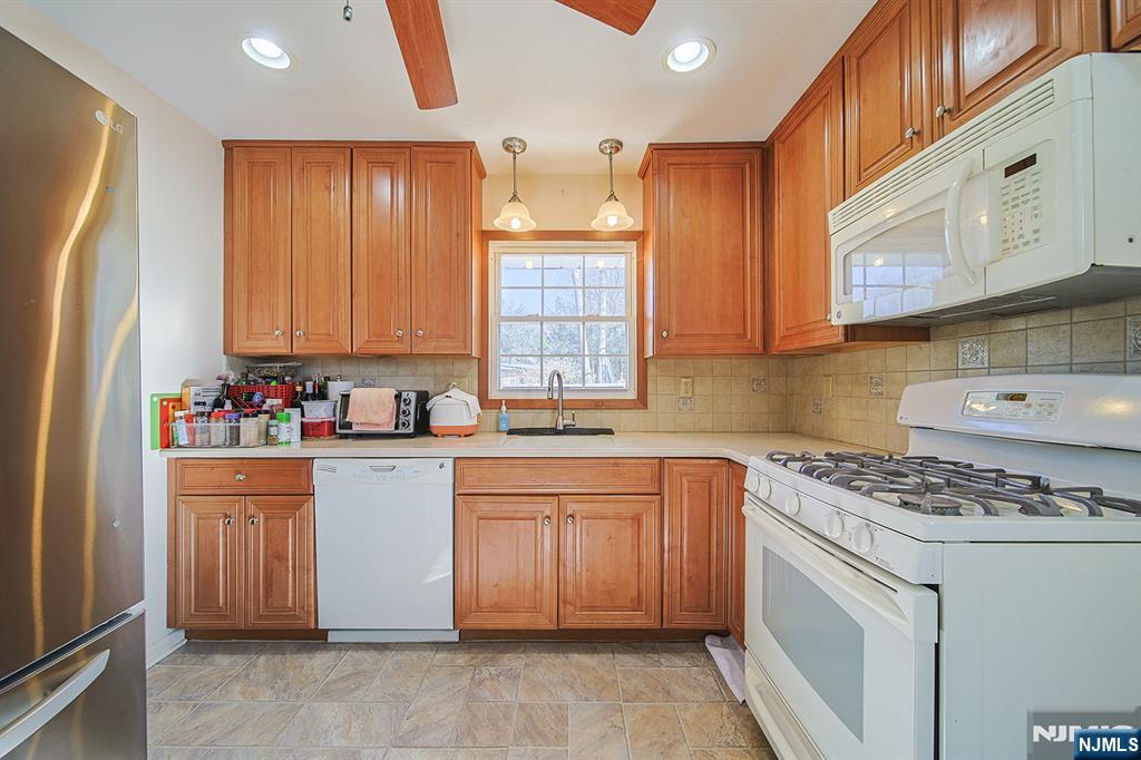 50 Knolls Road Bloomingdale, NJ 07403 - Photo 13 of 36 a kitchen with stainless steel appliances granite countertop a stove a sink dishwasher and a refrigerator