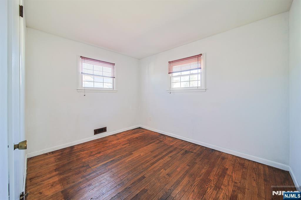 50 Knolls Road Bloomingdale, NJ 07403 - Photo 19 of 36 an empty room with wooden floor and windows