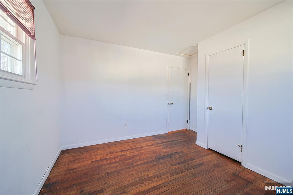 50 Knolls Road Bloomingdale, NJ 07403 - Photo 20 of 36 a view of an empty room with wooden floor and a window