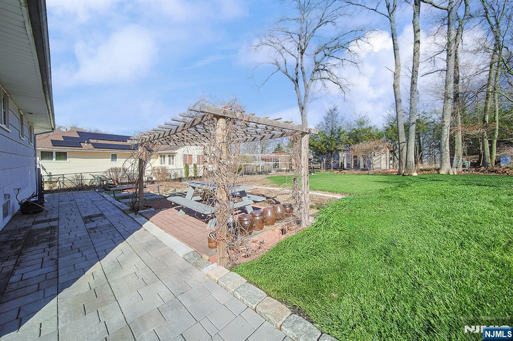 50 Knolls Road Bloomingdale, NJ 07403 - Photo 32 of 36 a view of a building with garden space and sitting area