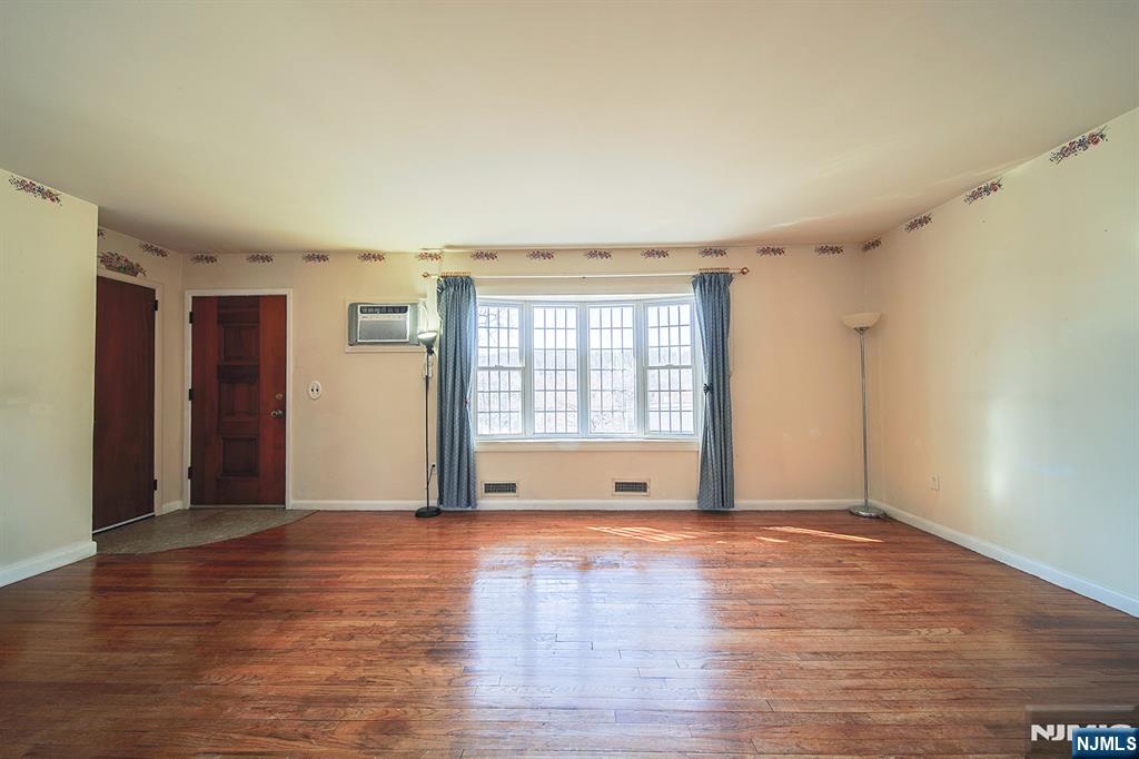50 Knolls Road Bloomingdale, NJ 07403 - Photo 4 of 36 a view of an empty room with wooden floor and a window