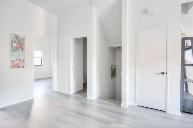 an empty room with windows and entrance