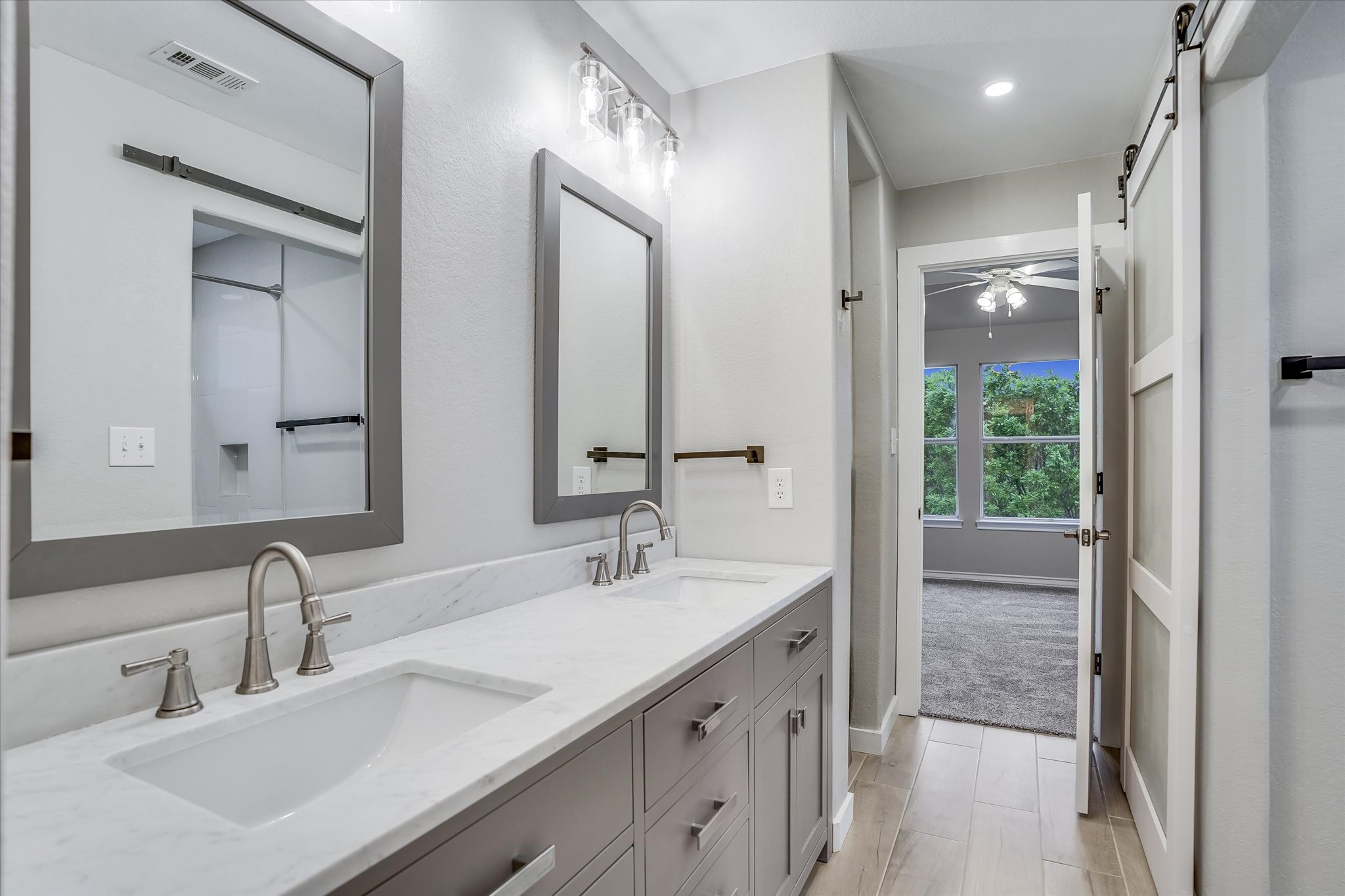 1400 Tom Sawyer Road Austin, TX 78737 - Photo 25 of 40 Jack-and-Jill bathroom with dual sinks and shared access.