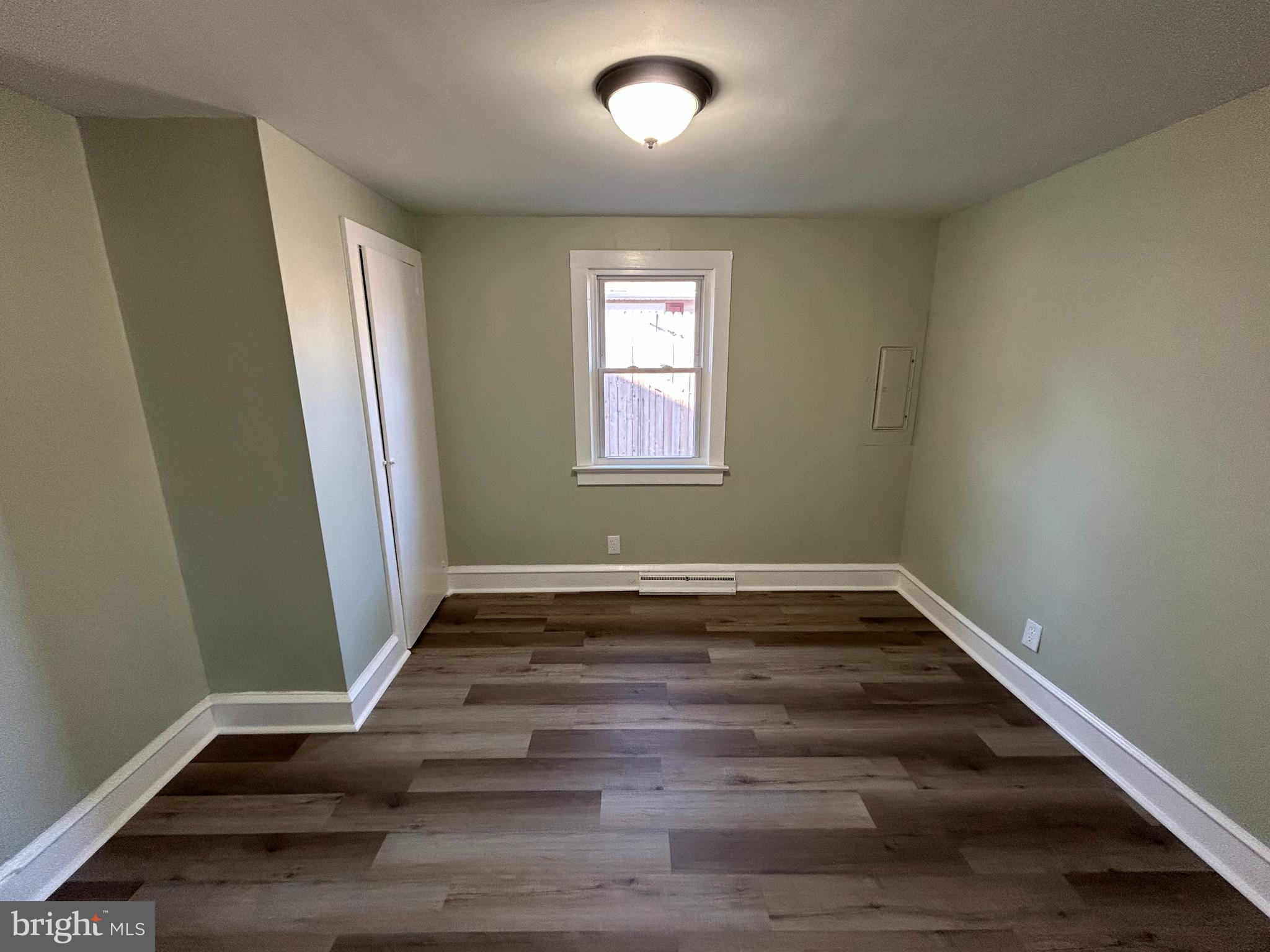 1 Michigan Road Pennsville, NJ 08070 - Photo 12 of 22 a view of an empty room with wooden floor and a window