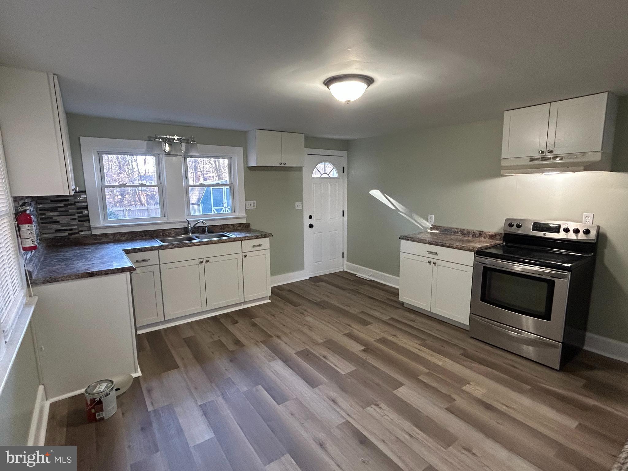 1 Michigan Road Pennsville, NJ 08070 - Photo 5 of 22 a kitchen with a sink stove and cabinets