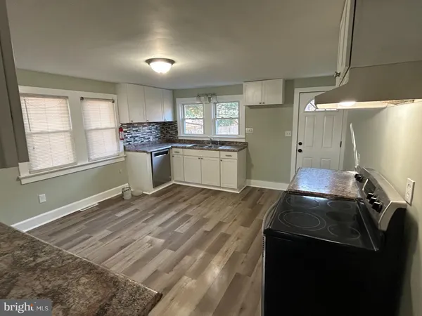 a kitchen with a stove and a refrigerator