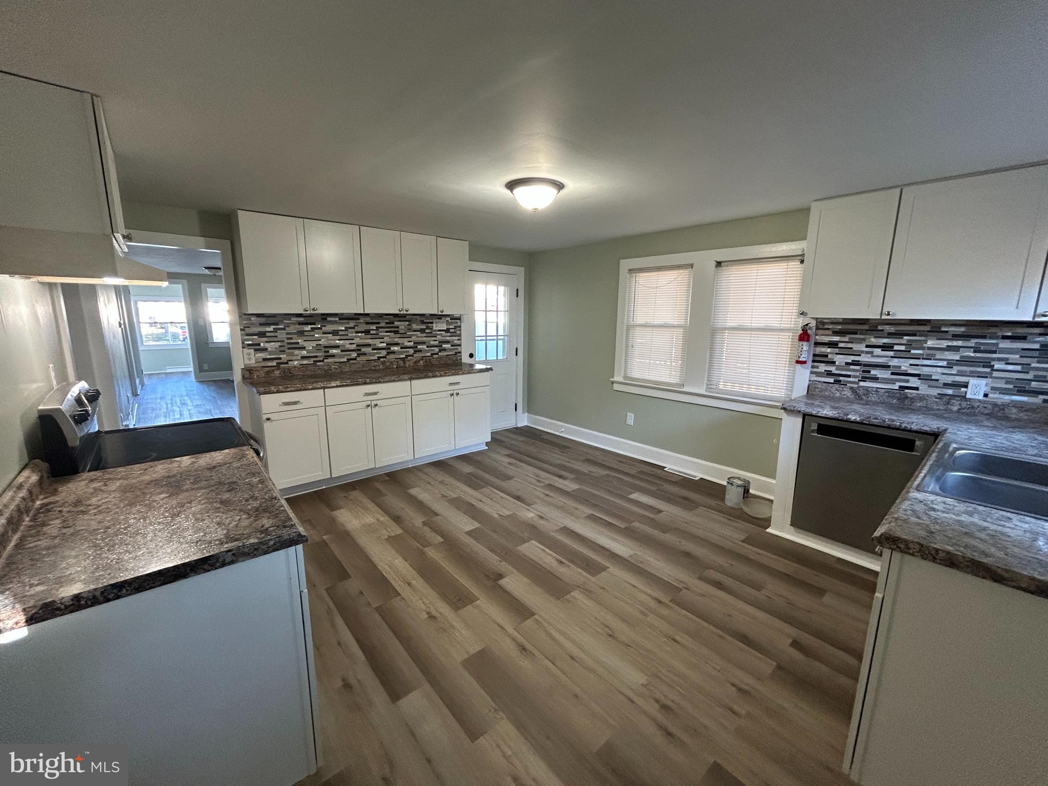 1 Michigan Road Pennsville, NJ 08070 - Photo 7 of 22 a kitchen with kitchen island granite countertop a sink stove and refrigerator