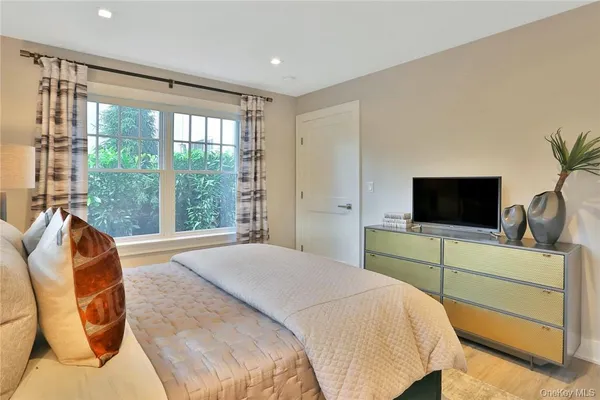 a bedroom with a bed and a television