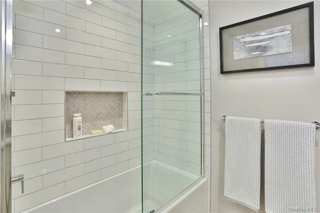 a bathroom with bathtub and shower