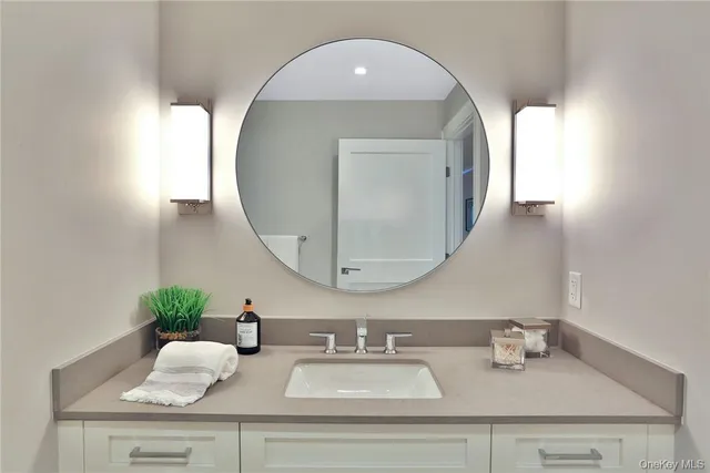 a bathroom with double vanity sinks and a mirror