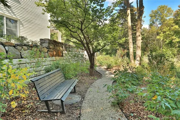 a view of a bench in backyard of the house