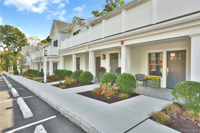 a front view of a house with yard and glass windows