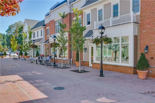 a row of palm trees in front of a building