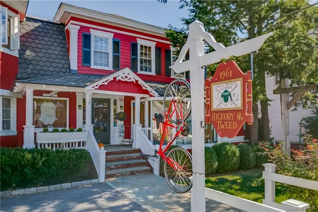 a front view of multi story residential apartment building with retail shops