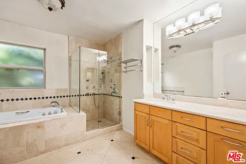 a bathroom with a tub sink and mirror