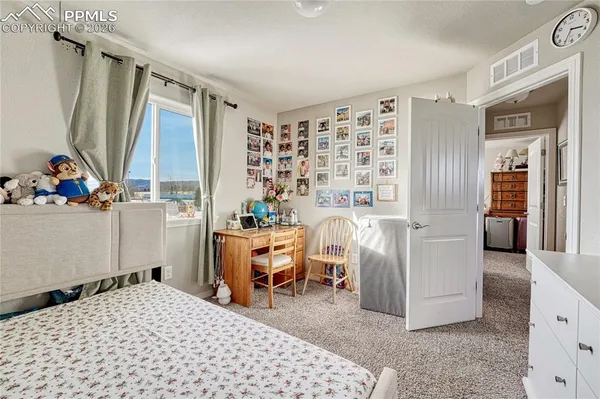 a bedroom with a bed and a dresser