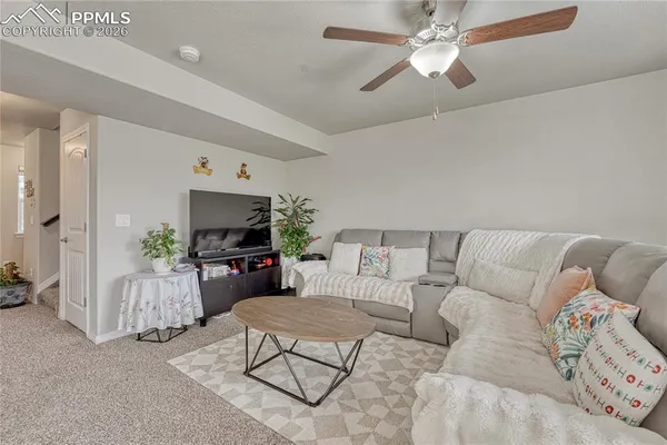 a living room with furniture and a large window