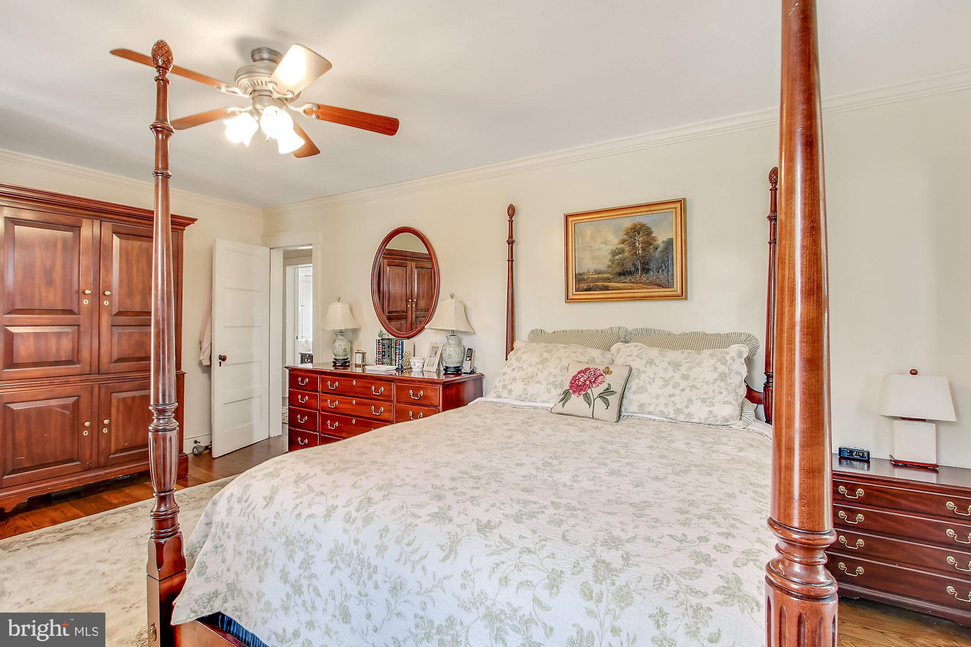 7260 Lentz Road Felton, PA 17322 - Photo 22 of 37 a bedroom with a large bed and a chandelier