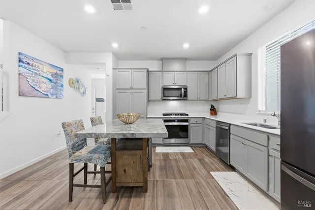 a bedroom with a bed a chandelier and a window
