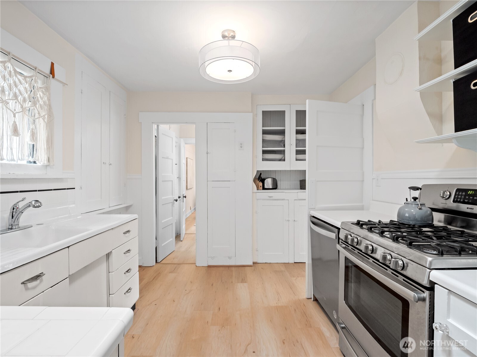 9701 Roosevelt Way Northeast Seattle, WA 98115 - Photo 11 of 33 a kitchen with cabinets appliances and a window
