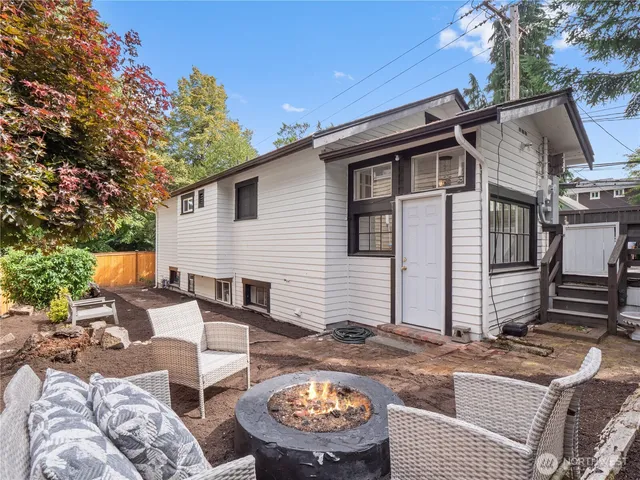 a view of a patio with couches chairs and a fire pit
