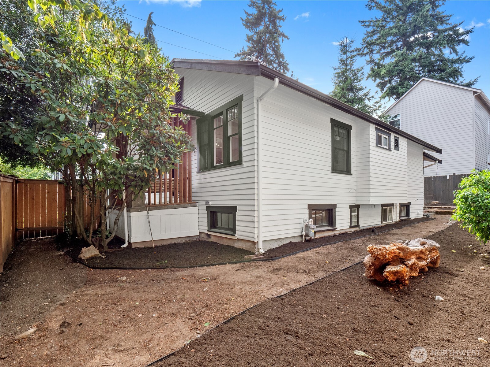 9701 Roosevelt Way Northeast Seattle, WA 98115 - Photo 19 of 33 a view of a white house with a large tree in front of it