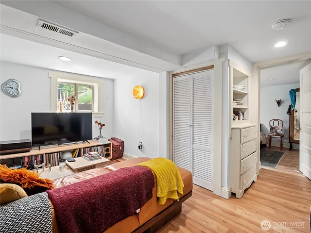 a bedroom with bed and a flat screen tv