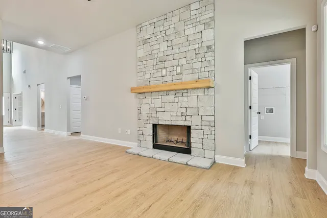 a view of an empty room and fire place