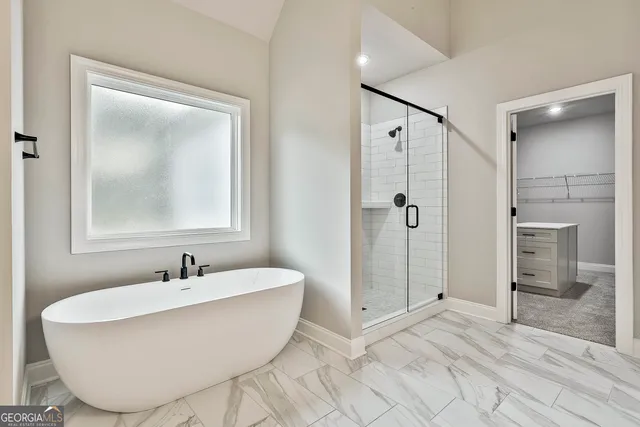 a spacious bathroom with a bathtub and a shower