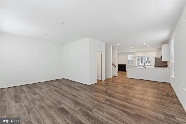 a view of a kitchen with wooden floor and a sink