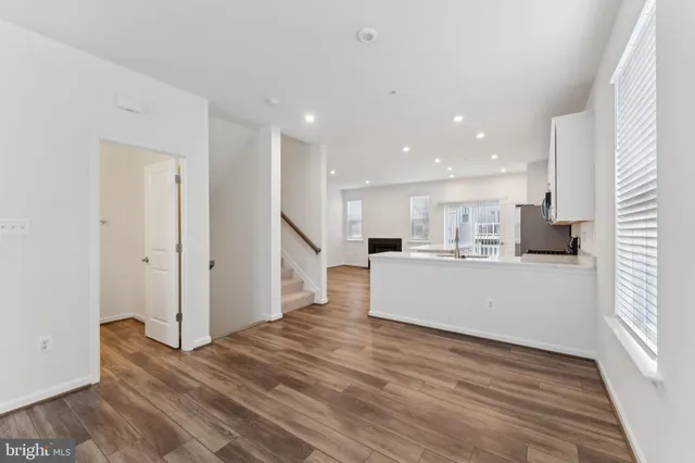 a view of kitchen with wooden floor and electronic appliances