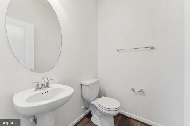 a bathroom with a sink a toilet and mirror