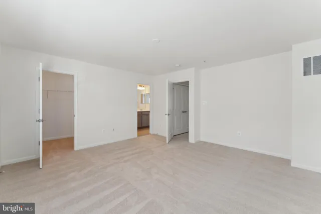 a view of an empty room with closet area