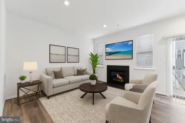 a living room with furniture a fireplace and a table
