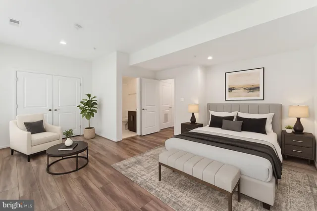 a bedroom with a bed and wooden floor