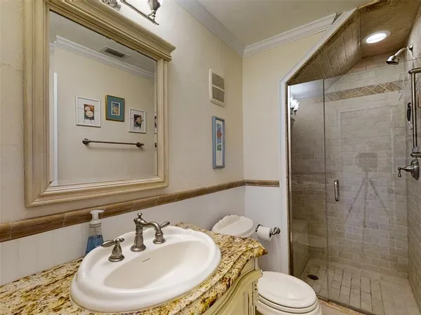 a bathroom with a sink toilet and shower