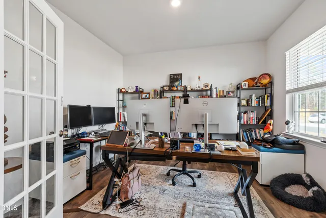 a view of a workspace with furniture and a window