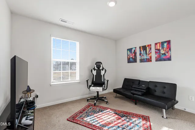 a living room with furniture gym equipment and a window
