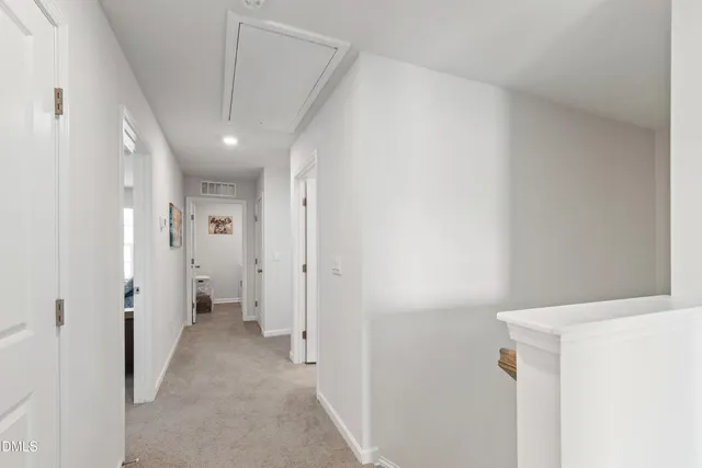 a view of a hallway with wooden shelves